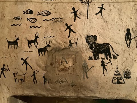 Children art in cave paintings on the stone wall