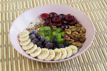 Oatmeal with banana, cherries, kiwi, blueberries, walnuts