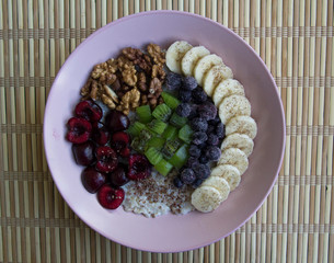 Oatmeal with banana, cherries, kiwi, blueberries, walnuts