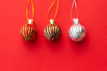 Christmas composition. Christmas red and golden decorations on red background. Christmas balls, dried oranges, homemade toys. Flat lay, top view, copy space