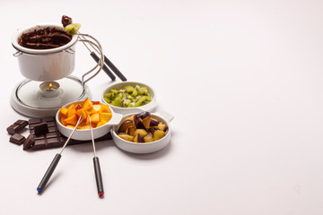 Chocolate fondue on white background