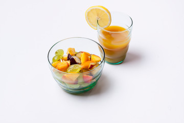 Fruit salad and orange juice isolated on white background.
