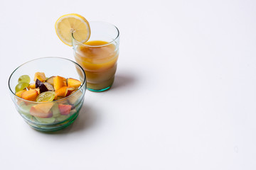 Fruit salad and orange juice isolated on white background.