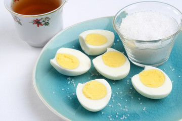 closeup sliced boiled eggs with salt