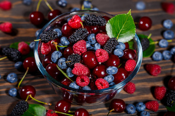Summer, ripe berries in a transparent bowl
