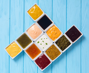 Set of different sauces in ceramic bowl