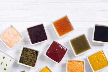 Set of different sauces in ceramic bowl