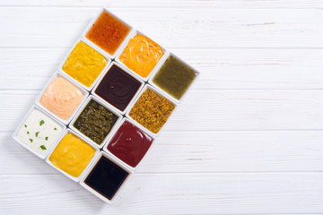 Set of different sauces in ceramic bowl