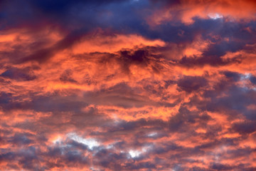Red clouds at sunset, fire on black background