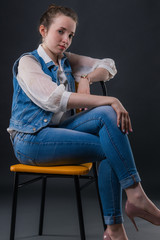 Portrait of a delightful business girl sitting on a chair