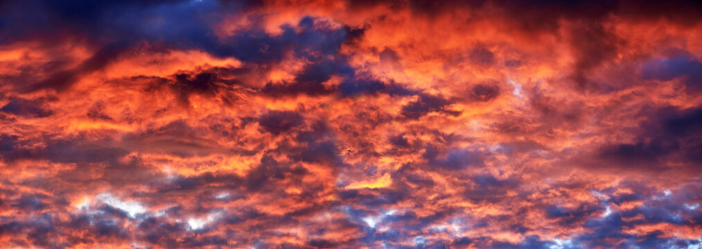 Red clouds at sunset, fire on black background