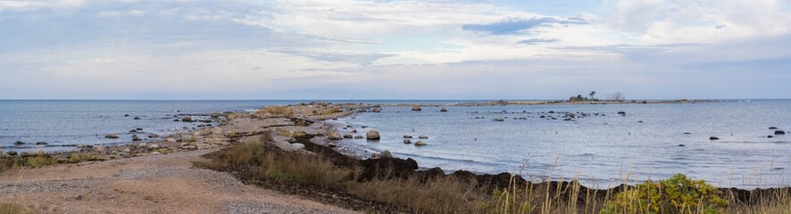 Panorama of Cape Purekkari, 1.5 km long, covered with rocks and boulders, and located on the Pärispea Peninsula in Lahemaa National Park. Thorny Japanese rose bushes on sandy beach.