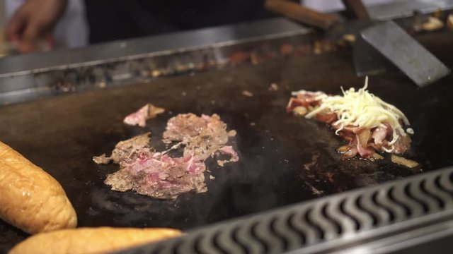 Cooking Philly's cheese steak sandwich at festival stall