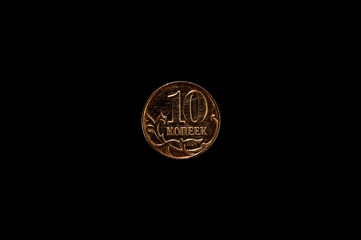 Coin on black background close-up. Money, currency, business