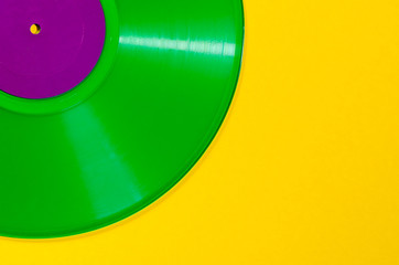 Green vinyl record on yellow background - Retro concept