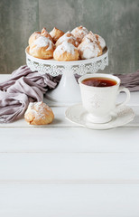 Stack of small eclair cakes filled with vanilla cream.