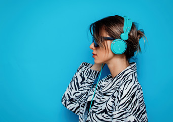 Young woman in zebra clothes and headphones © Masson