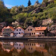 Fototapeta na wymiar Houses on Vltava River in medieval town of Cesky Krumlov in Czech Republic. Cesky Krumlov is a UNESCO World Heritage Site.