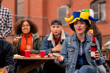 Group of young tense friendly football fans watching broadcast at leisure