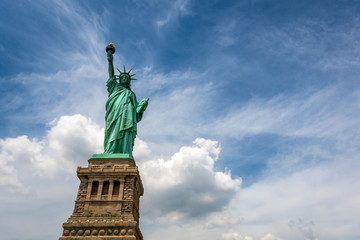 Obraz premium Statue of Liberty on Liberty Island closeup with blue sky in New York City Manhattan - Image