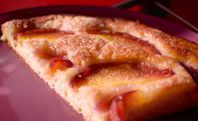 Appetizing slice of airy crumbly pie with fruit pieces.