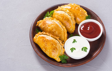 Latin American baked beef empanadas with sauce