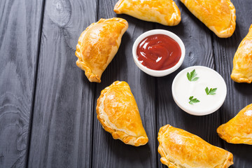 Latin American baked beef empanadas with sauce