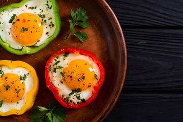 Yellow , red and green pepper with fried eggs