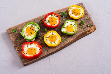 Yellow , red and green pepper with fried eggs