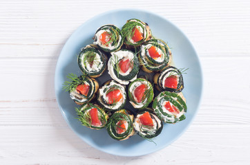 Zucchini rolls with cream cheese , tomatoes and dill