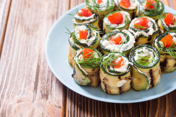 Zucchini rolls with cream cheese , tomatoes and dill
