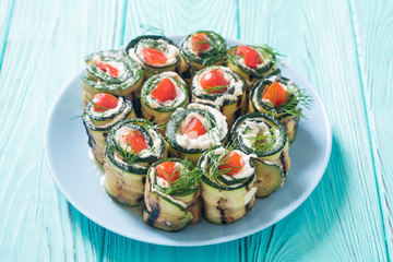 Zucchini rolls with cream cheese , tomatoes and dill
