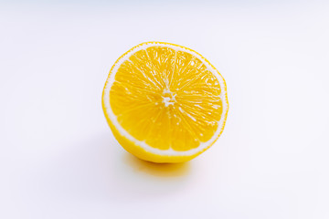 lemon cut in two with a white background