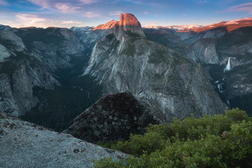 Half Dome and Yosemite Valley in Yosemite National Park during colorful sunset with trees and rocks. California, USA Sunny day in the most popular viewpoint in Yosemite. Beautiful landscape background