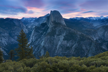 Half Dome and Yosemite Valley in Yosemite National Park during colorful sunset with trees and rocks. California, USA Sunny day in the most popular viewpoint in Yosemite. Beautiful landscape background