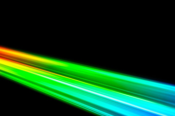 Beams of light refracting and creating a rainbow spectrum of colours against a black background