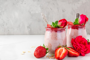 healthy diet breakfast dessert. strawberry overnight oats with fresh berries and mint with rose flowers