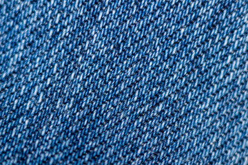 Macro texture of blue denim. Close-up with selective focus. Original background. Interesting pattern