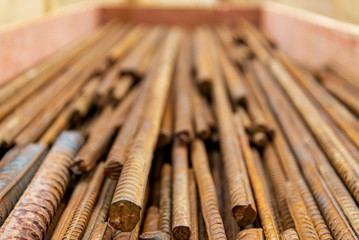 Close up selected focus view stack of straight old rusty high yield stress deformed reinforcement...
