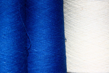 Close up view of blue and white cotton bobbins