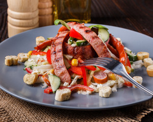 Salad with grilled sausage paprica cucumber and croutons