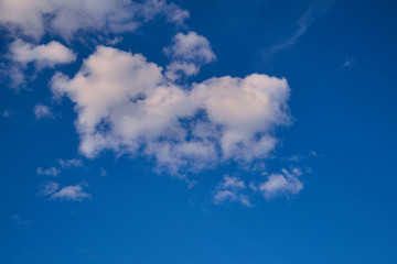 Blue summer sky white cumulus clouds background.
