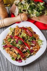 Mexican salad with hot pepper chiken fillet lettuce on plate