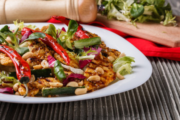 Mexican salad with hot pepper chiken fillet lettuce on plate