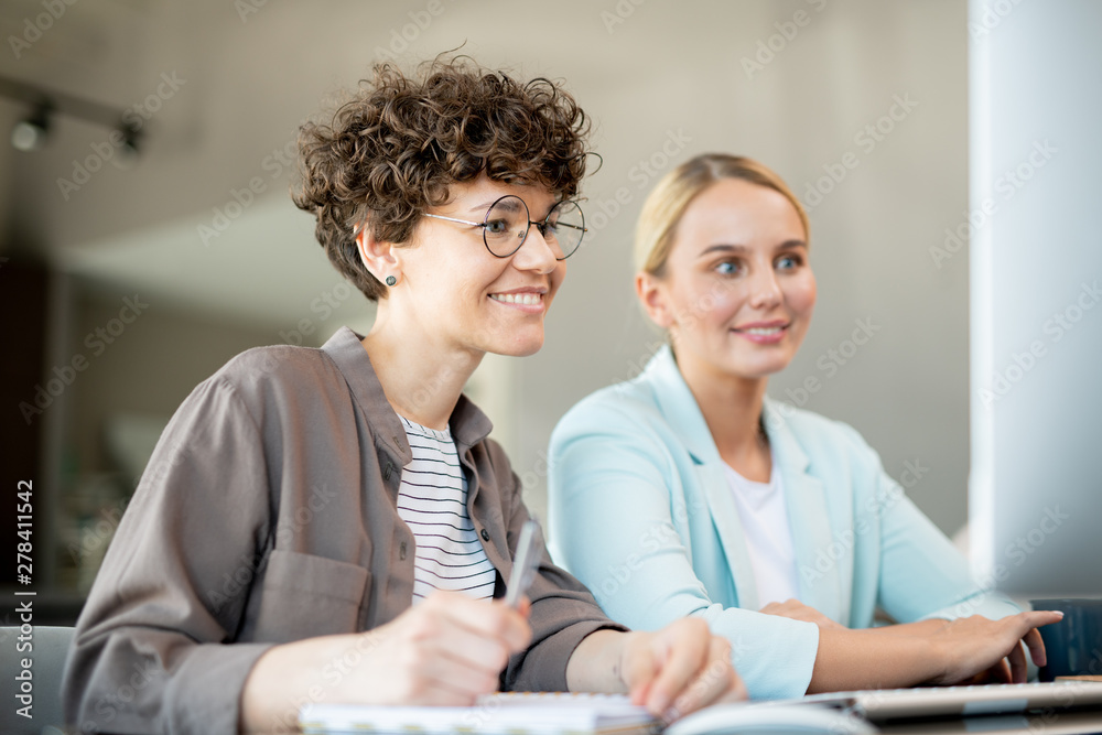 Aufkleber two happy female colleagues looking at data on computer screen