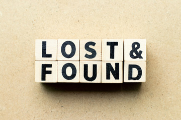 Letter block in word lost & found on wood background