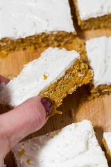carrot cake with icing, vertical closeup