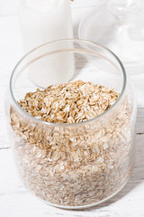 glass jar with oat flakes, vertical