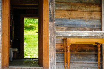 Folk wooden dwelling in the Carpathians in Ukraine. Through the door open to the yard.