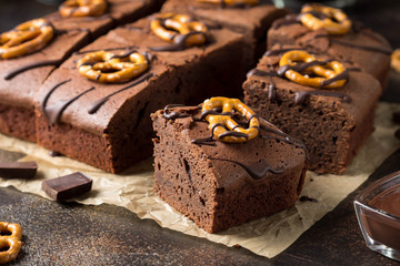 Chocolate brownie on dark beer with salted pretzels and chocolate. Delicious brutal dessert for men, sweet food